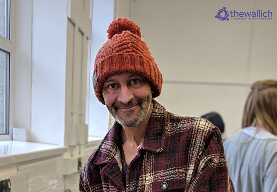 Male service user taking part in a cooking class at The Wallich project in Neath Port Talbot